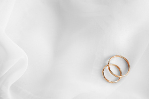 wedding rings on white material