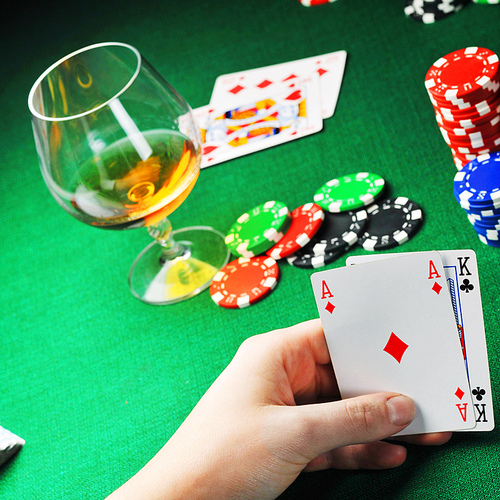 man  sitting at the gambing table and  playing cards