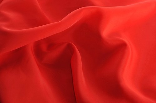 red graceful fabric close up|background
