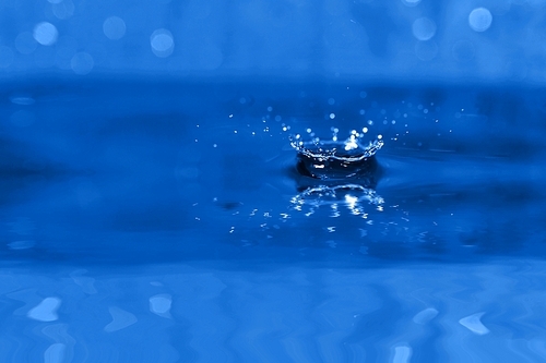 Close-up of  water splash on  blue background. Water abstract