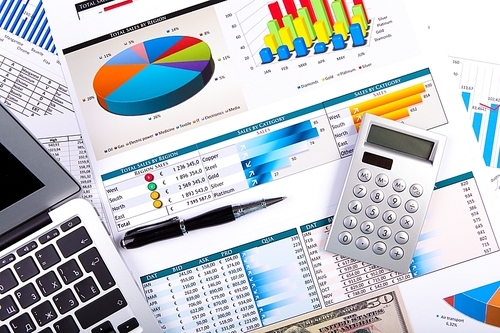 Financial paper charts and graphs on the table