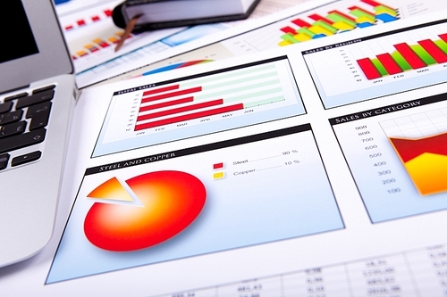 Financial paper charts and graphs on the table