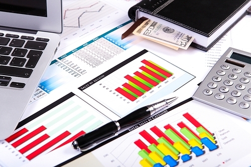 Financial paper charts and graphs on the table