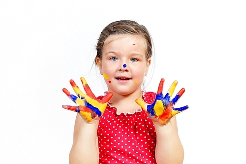 little child with hands painted in colorful paints ready for hand prints