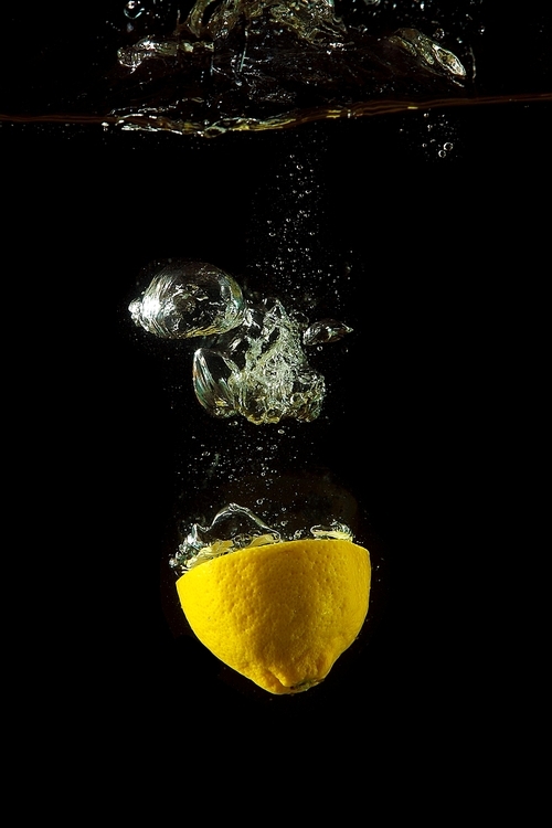 Bright and juicy lemon under water. Fresh and healthy meal