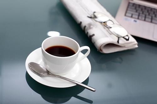 Image of business table with a cup of coffee and norebook