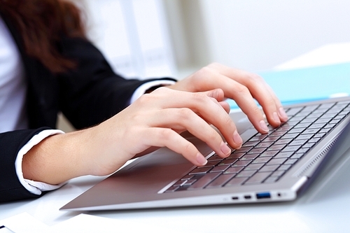 Young pretty business woman with notebook in the office