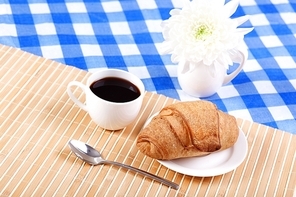 Continental breakfast with croisant and black coffee