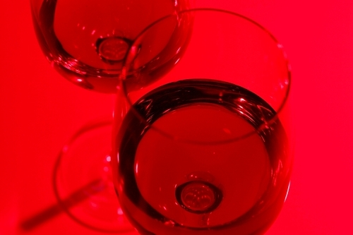 Glasses with wine on the color background