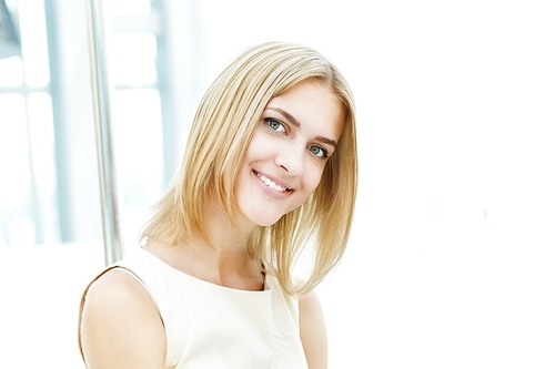 Portrait of a young blond woman sitting in cafe