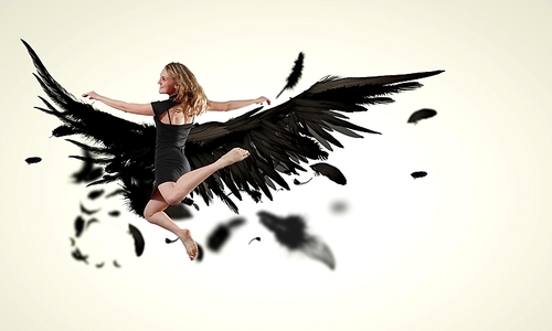 Woman floating   on dark wings