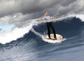 Image of young business person surfing on the waves of the ocean