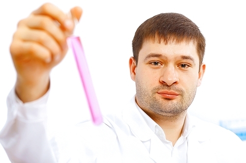 Young male scientist working with liquids in laboratory