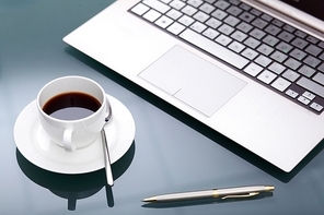Image of business table with a cup of coffee and notebook