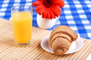 Continental breakfast with croissant and orange juice