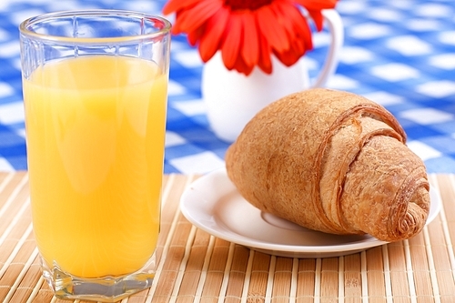 Continental breakfast with croissant and orange juice