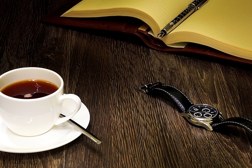 A cup of black coffee and a book