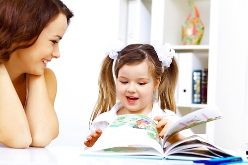 Little girl sitting and studying at home