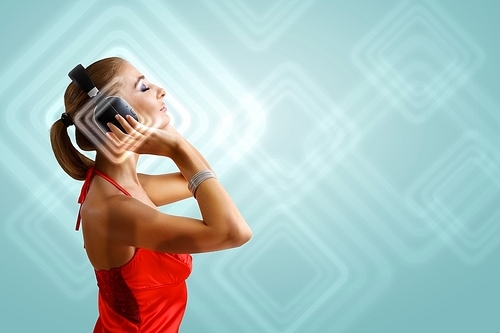 Portrait of young woman with headphones and glittering background