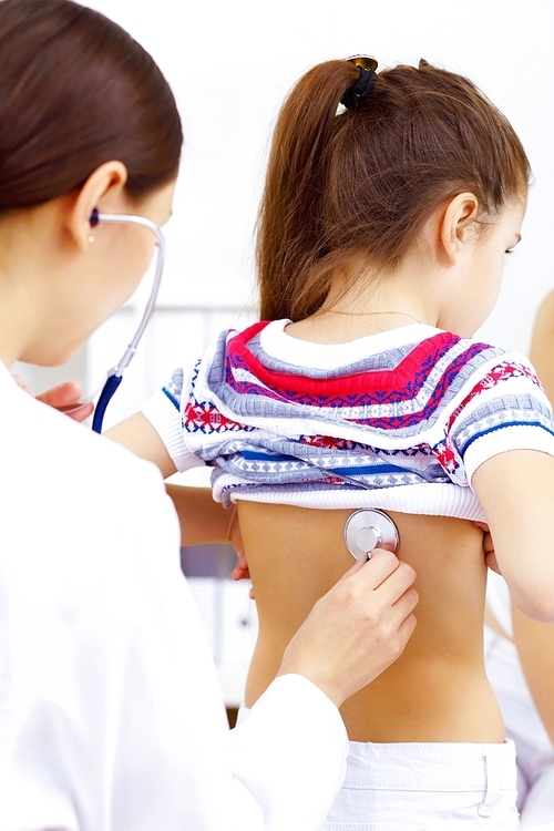 Little girl and young doctor in hospital having examination