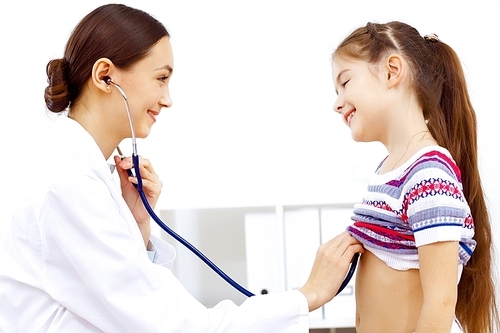 Little girl and young doctor in hospital having examination