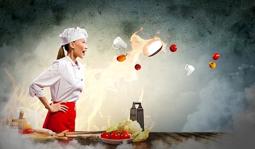 Asian female cook in anger with flyung vegetables against color background with shine effects