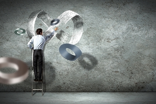 Image of businessman drawing infinity sign on wall