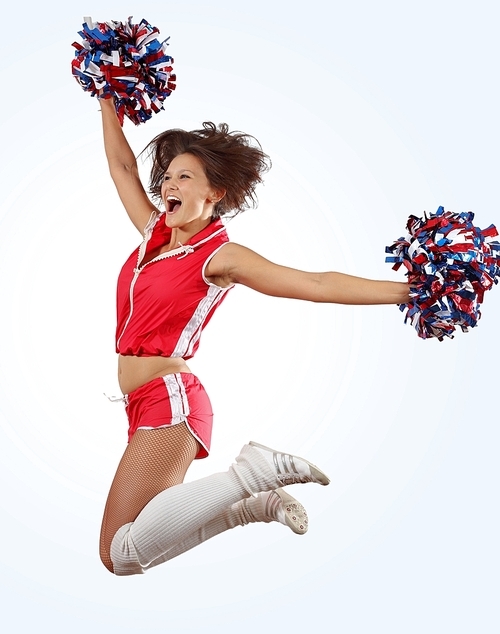 Uniformed cheerleader jumps high in the air   isolated on white.