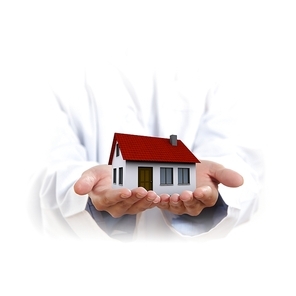 Residential building and a businessman holding it in his hands