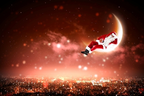 Santa Claus on the moon above a city at night