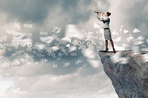 Image of businesswoman looking in telescope standing a top of rock