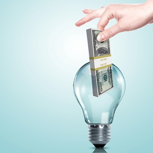 Hand and money inside an electric light bulb