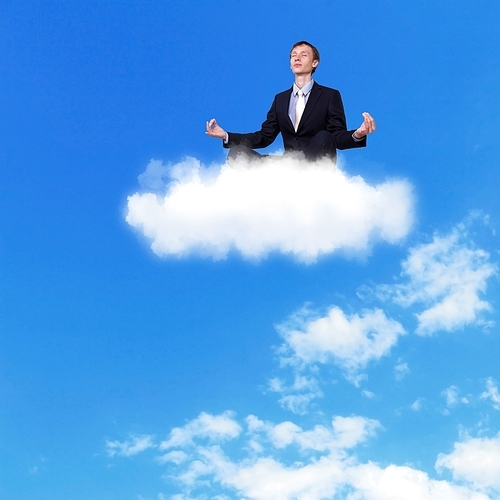 Businessman meditating sitting on the white cloud