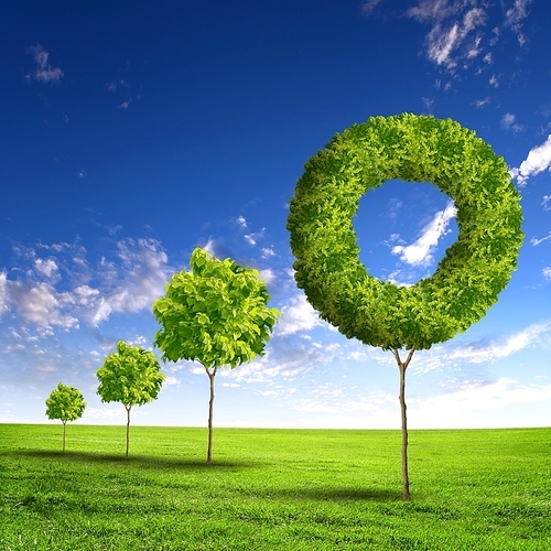 Green grass shape against blue sky with clouds