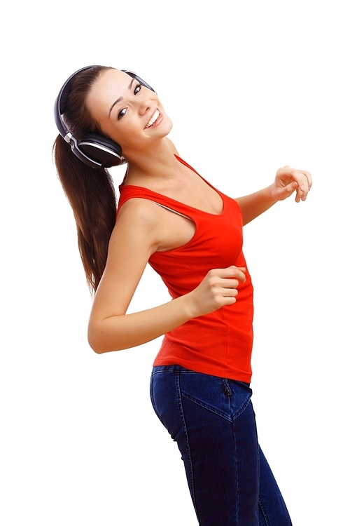 Happy smiling girl dancing and listening to music