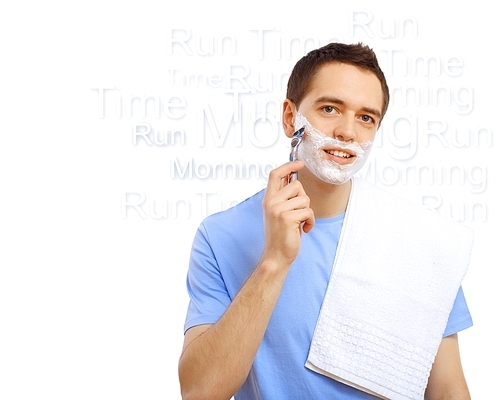 Young man in blue T-shirt shaving himself