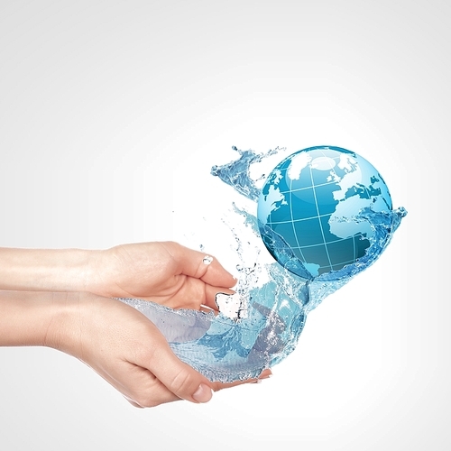 Globe in human hand against blue sky. Environmental protection concept. Elements of this image furnished by NASA