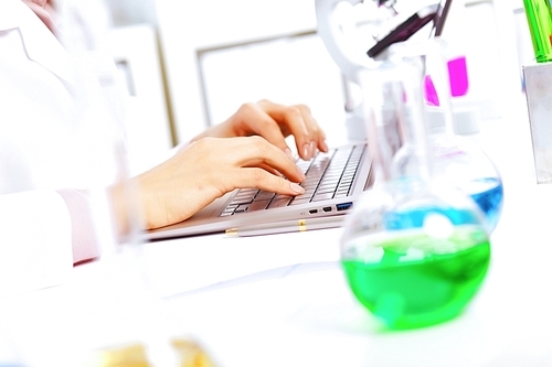 Young female scientist working with liquids in laboratory