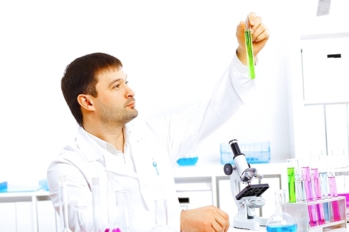 Young male scientist working with liquids in laboratory