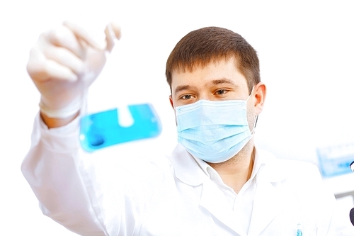 Young male scientist working with liquids in laboratory