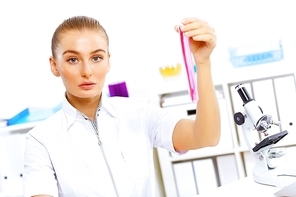 Young female scientist working with liquids in laboratory