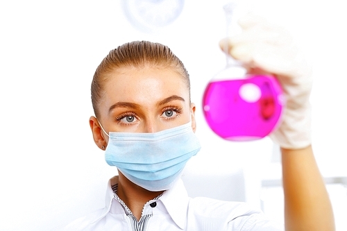 Young female scientist working with liquids in laboratory