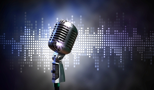 Single retro microphone against colourful background with lights