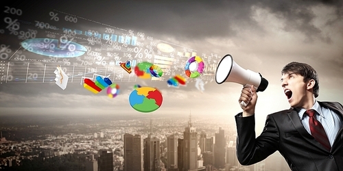 young businessman in black suit screaming into megaphone