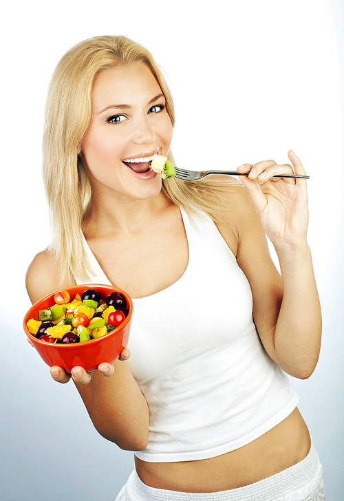 Pretty girl eating fruit salad, healthy fresh breakfast, dieting and health care concept