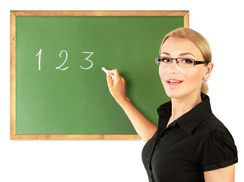 Young teacher writing numbers on the chalkboard, isolated on white, conceptual image of education