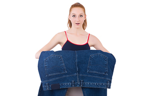 Woman with large jeans in dieting concept