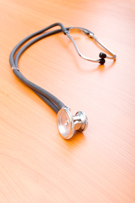 Medical concept - stethoscope on the wooden table