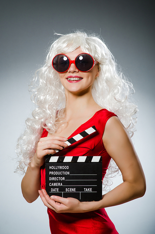 Blond woman with movie board