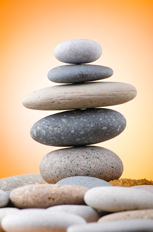 Balanced pebbles with colour background